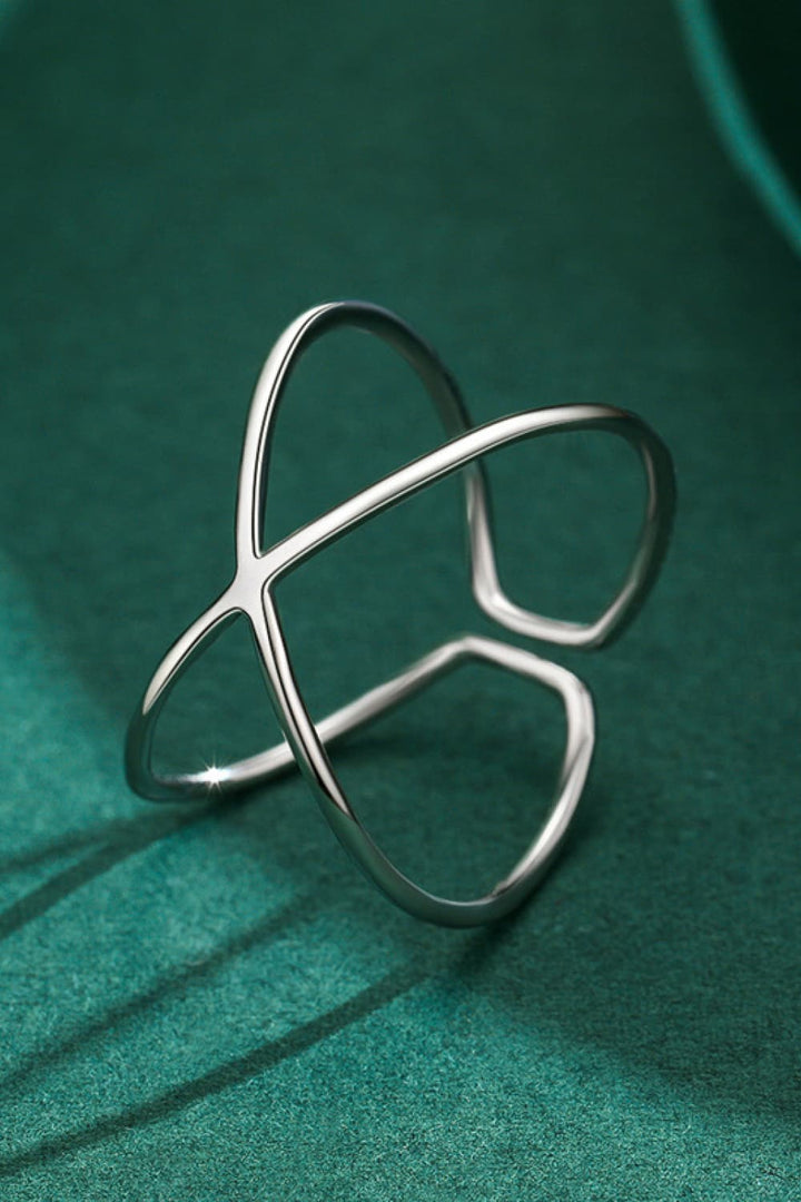 Sterling silver ring, Open design, Crisscross ring, Elegant jewelry, Unique silver ring, Contemporary design, Adjustable silver ring, Fashionable accessory, Fine silver jewelry, Statement piece.