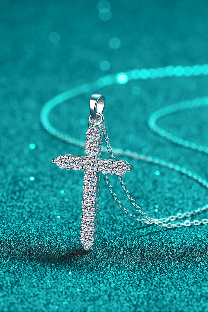 Sterling silver necklace, Cross pendant, Moissanite gemstone, Elegant jewelry, Religious necklace, Sparkling centerpiece, Fine silver accessory, High-quality craftsmanship, Timeless beauty, Meaningful necklace.